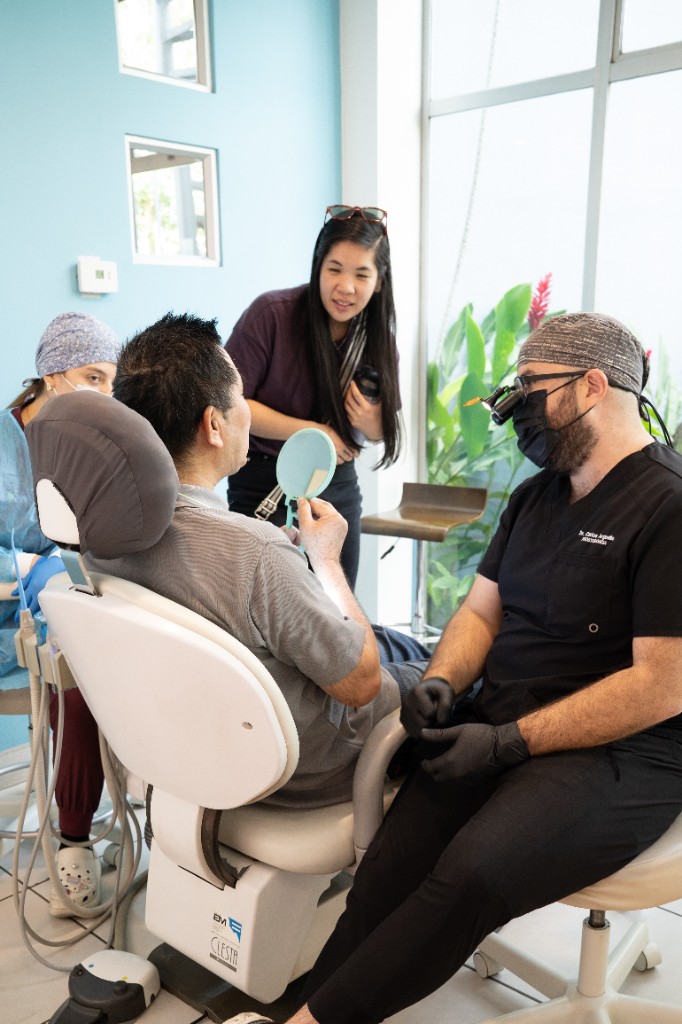 Paciente revisando su sonrisa con el dentista en consultorio de Colina Dental, Costa Rica